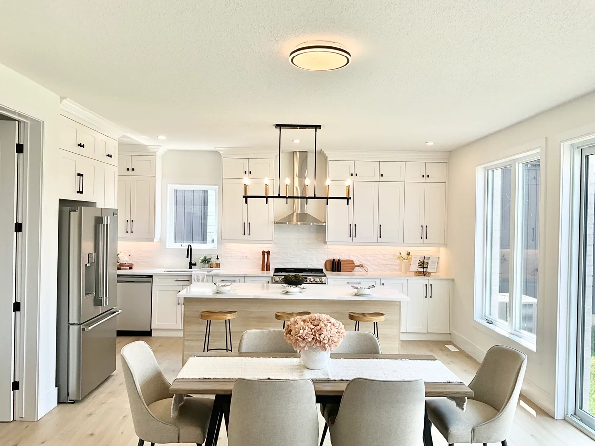 Starlit Homes kitchen and dining area with island seating and natural light in Ailsa Craig Ontario