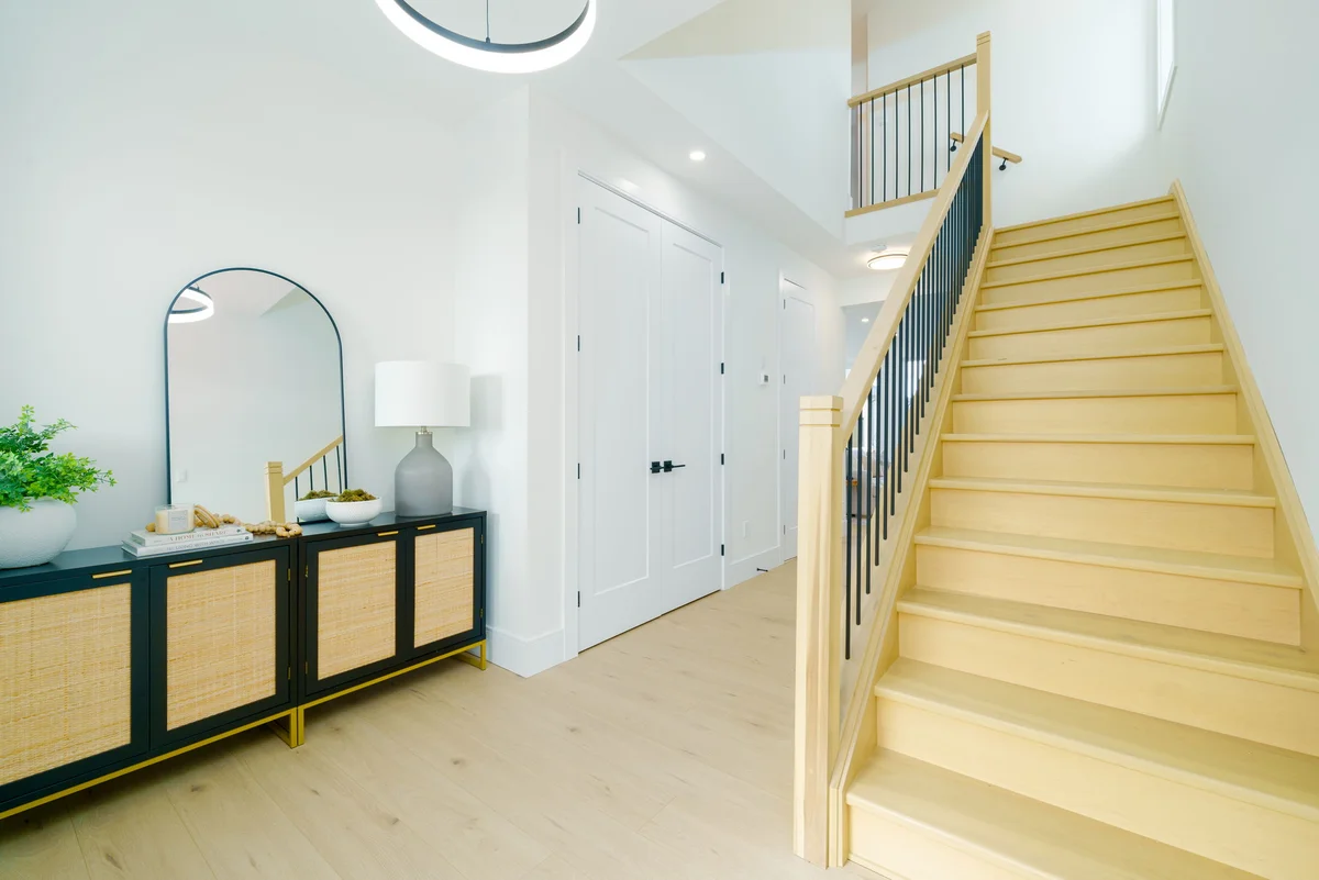 Starlit Homes oak and iron staircase with ring pendant light in custom home Ailsa Craig Ontario