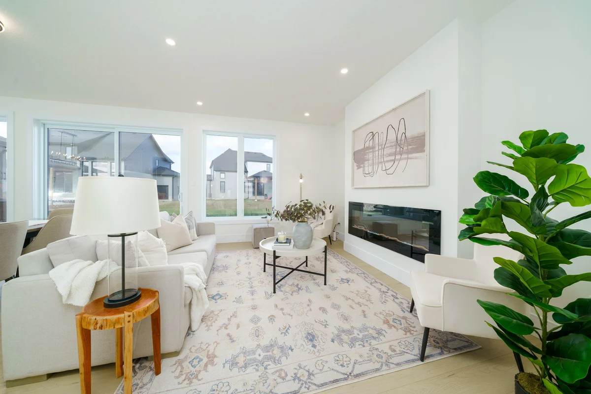 Starlit Homes open-concept living room with linear fireplace in Ausable Bluffs Ailsa Craig Ontario