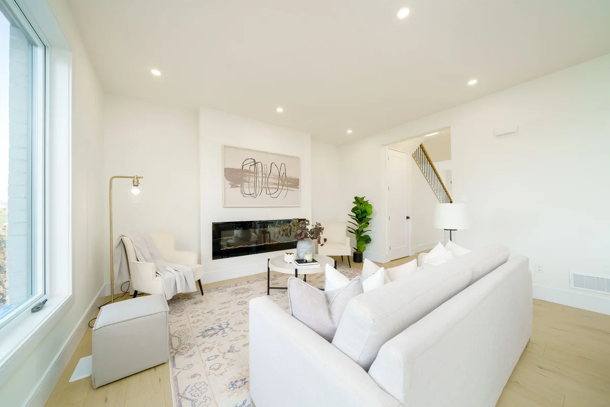 Starlit Homes living room alternate angle showing fireplace and staircase in Ailsa Craig Ontario