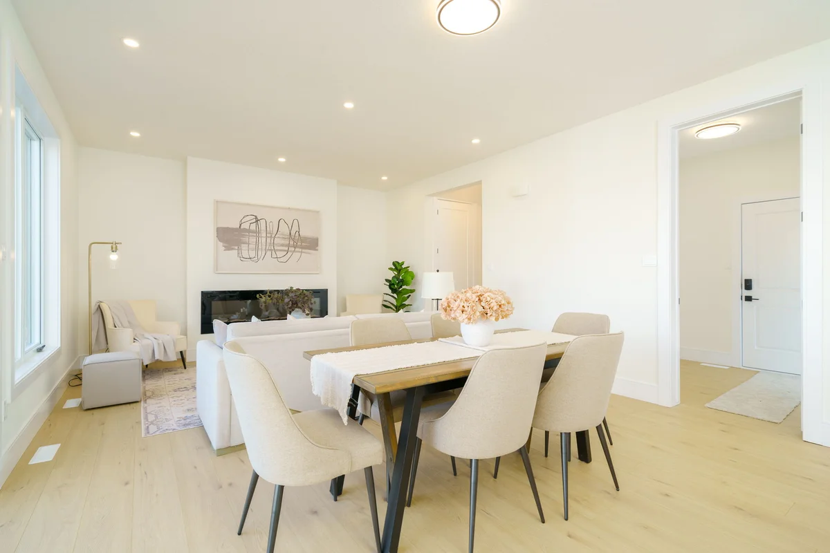 Starlit Homes open dining and living area with linear fireplace in custom home Ailsa Craig Ontario