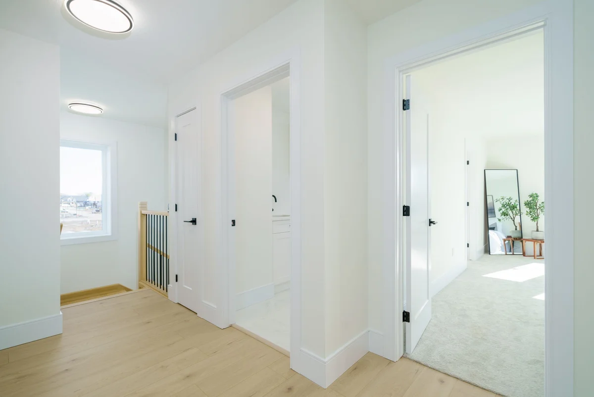 Starlit Homes open-plan living area with exposed beam and modern kitchen in Ausable Bluffs Ailsa Craig Ontario