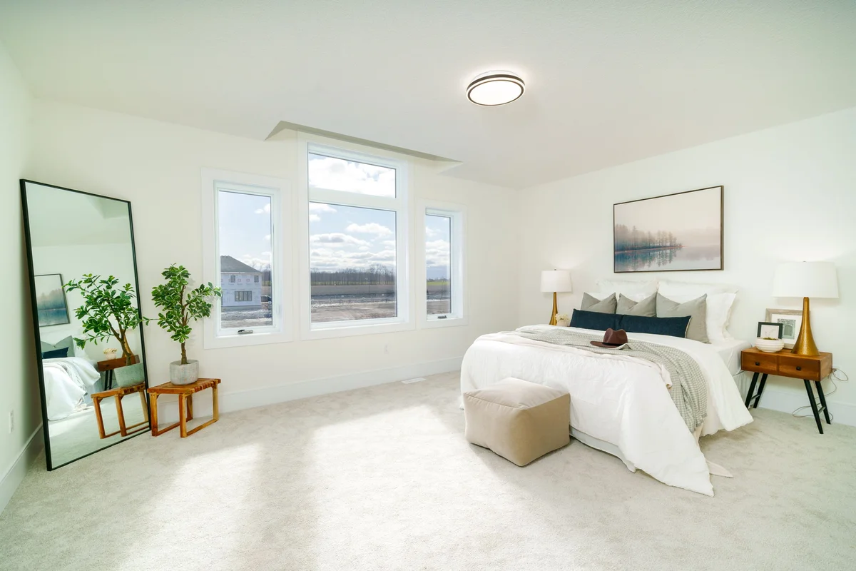 Starlit Homes spacious master bedroom with triple windows and natural light in Ailsa Craig Ontario